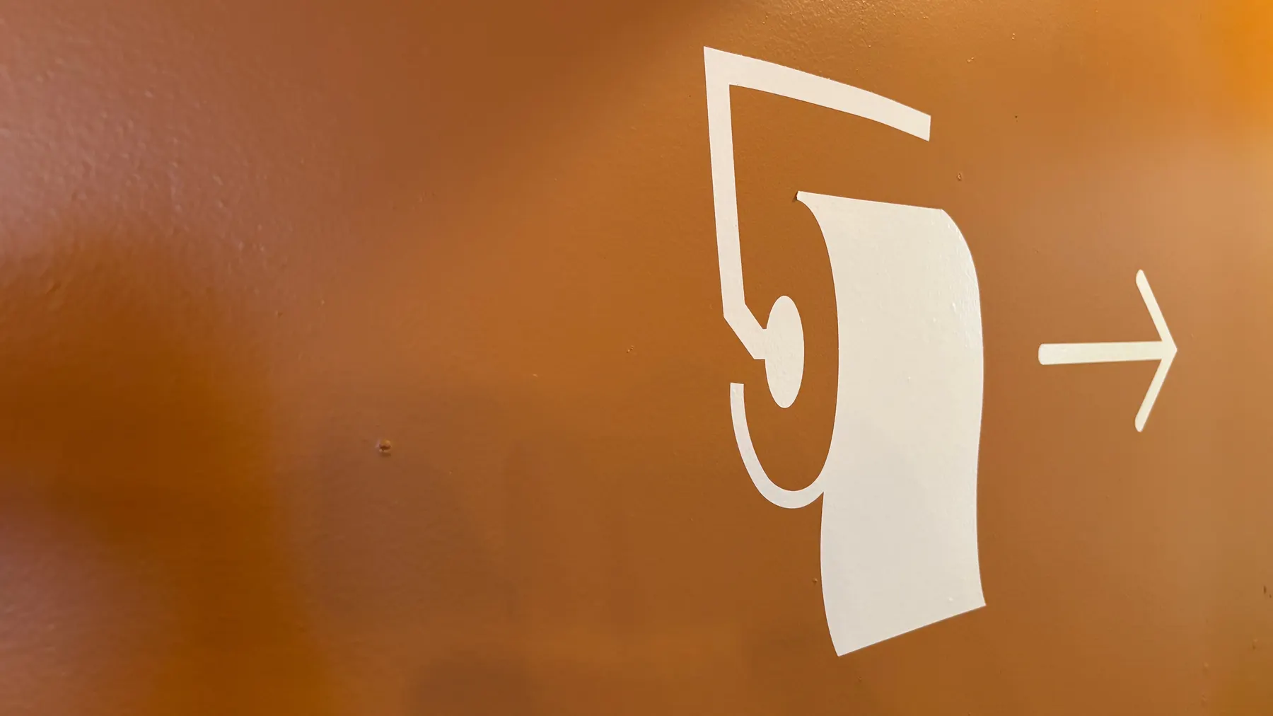 Close view of a smooth painted surface in a warm ochre tone